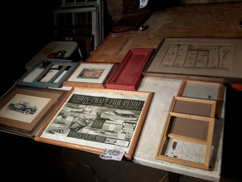 lot 202 image: Misc. Pictures and picture frames.. Note the CRIS CRAFT theme display.