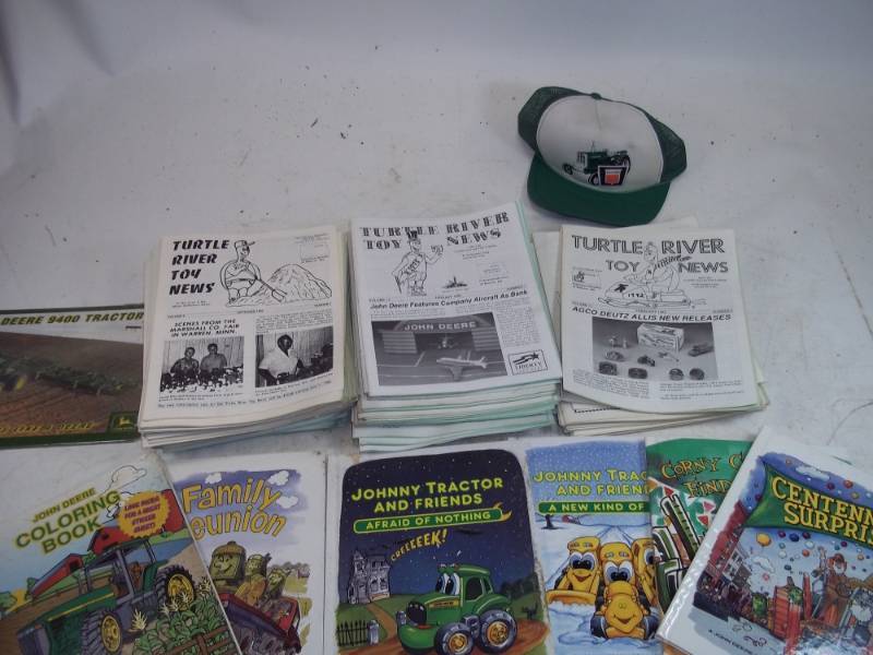 lot 109 image: Turtle River Toy News magazines, books, John Deere Hat, John Deere coloring book