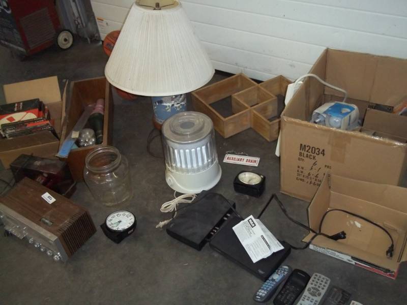 lot 128 image: Basketballs, Lamp, universal remote controls, AMFM Cassette Radio, kitchen junk drawer, shelf, chicken waterer glass etc.