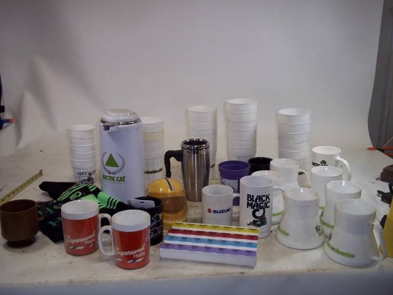 lot 225 image: Assorted Cups and mugs, Suzuki Ceramic Helmet, Artic Cat cups, Artic cat Stockings, Coffee Thermos, Weekly Pill Organizer
