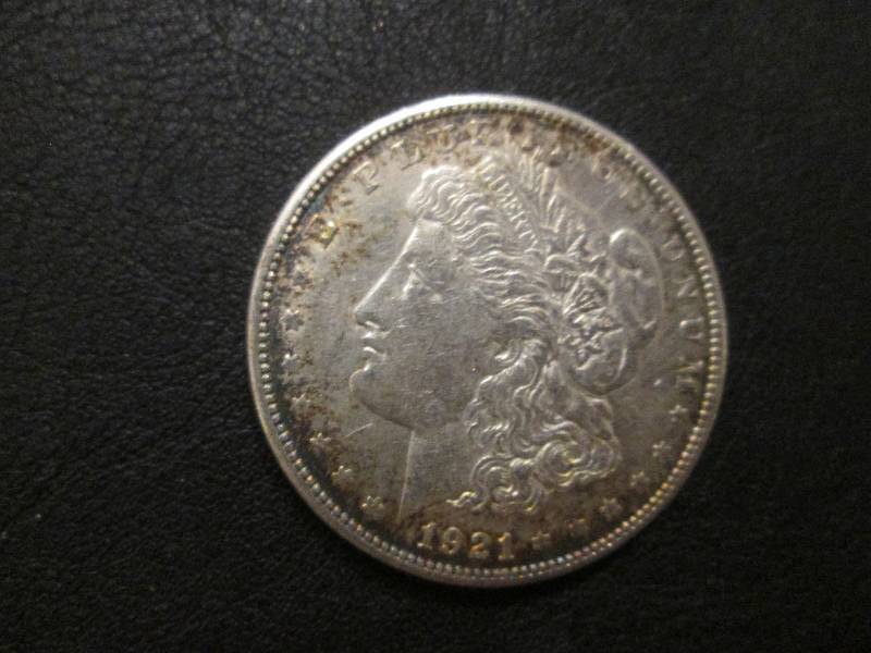 lot 9 image: 1921 S Morgan Dollar...