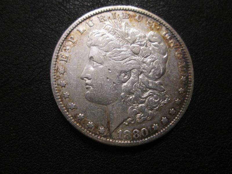 lot 11 image: 1880 Morgan Dollar...