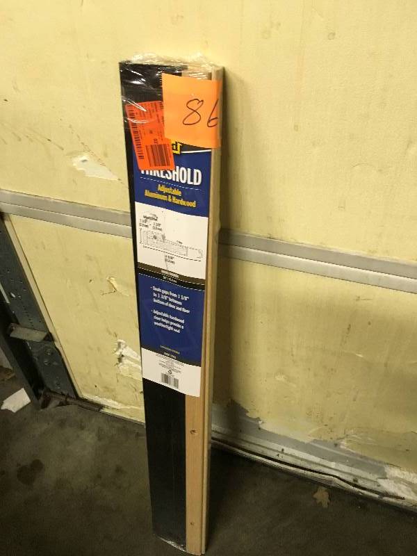 lot 86 image: M-D Building Products 36 in. Bronze Anodized & Oak Adjustable Hardwood Sills  open box not used