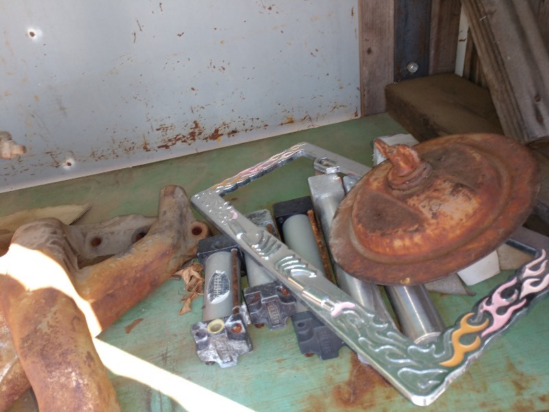 lot 83 image: Industrial Parts, License Plate Cover, Red Yoke-Like Bar, and Blue Bin and Chains