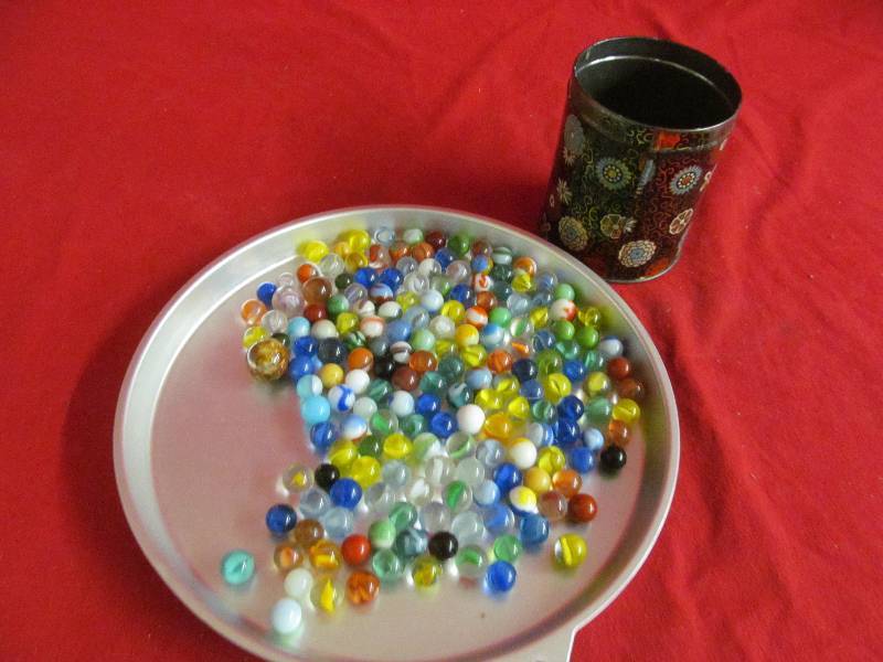 lot 27 image: vintage marbles, vintage tin can