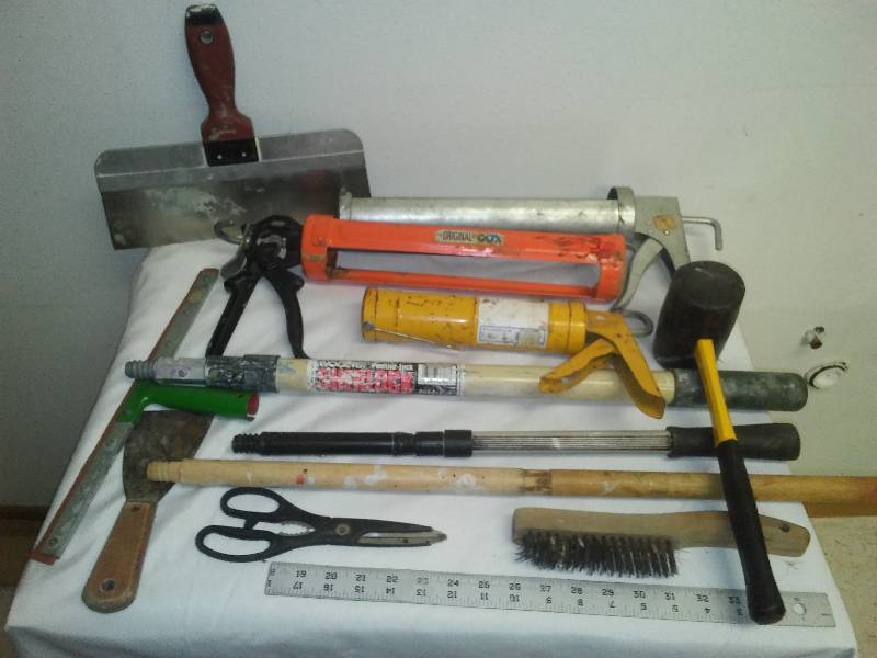 lot 120 image: Caulk Guns, extender handles, drywall blade, rubber mallet and more