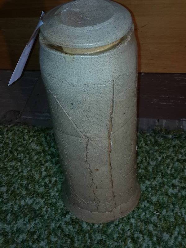 Cream colored ceramic jar with lid 6 in diameter x 16 h