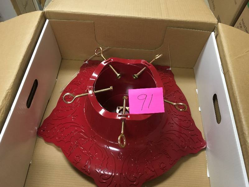 lot 91 image: Decorative Red Tree Stand Up to 10 ft Tree open box not used