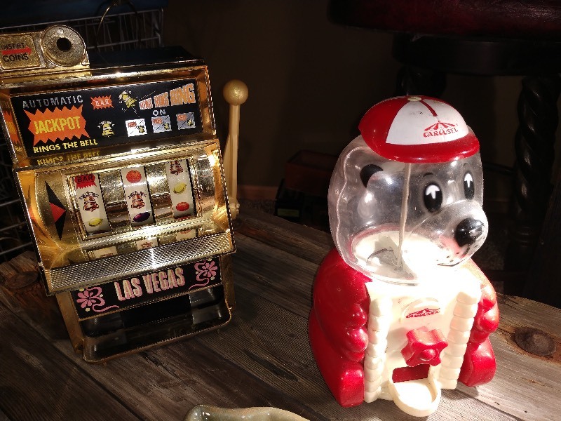 lot 32 image: Pirate w Bird Pottery, Texas Shaped Pottery, Slot Machine, and Carousel Gumball Machine