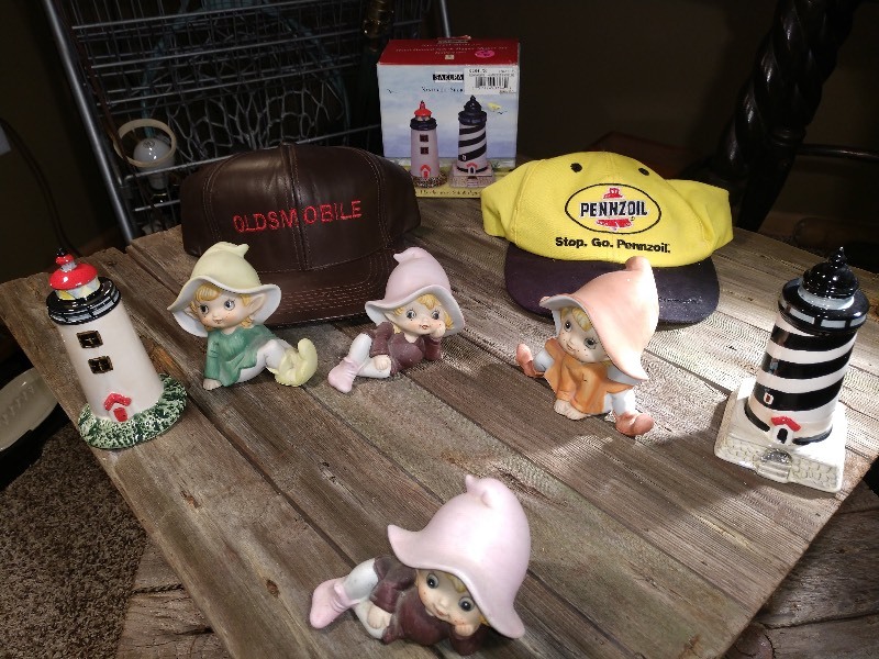 lot 46 image: Gnome Figurines (4), Hand Painted Lighthouse Salt and Pepper Shaker Set, Oldsmobile Hat, Pennzoil Hat