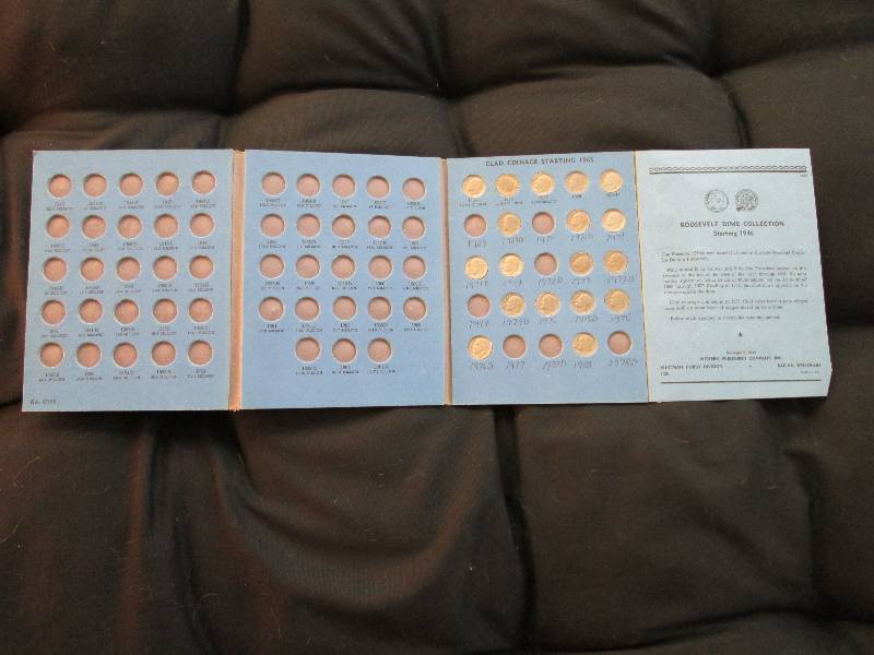 Book of Roosevelt Dimes with coins ...