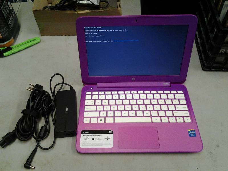 lot 11 image: Pink HP Stream Mini Lap Top 12 Inch, Has Been Wiped Clean, Needs Operating System Reinstalled, With Charger. Powers On & Holds Charge.