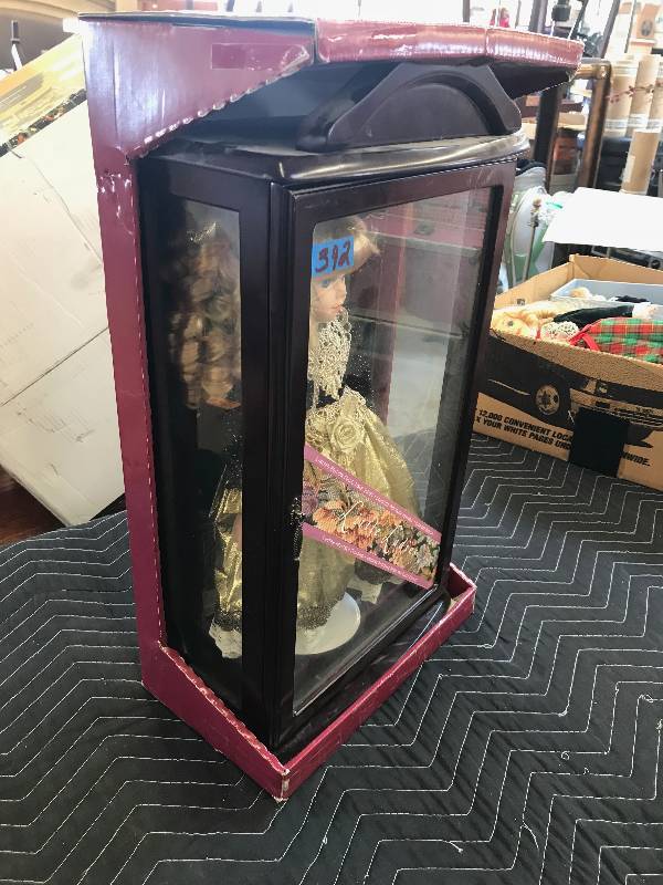 lot 392 image: DOLL IN A WOOD AND GLASS CABINET