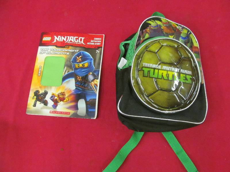 lot 56 image: Ninja turtle back pack, and activity book