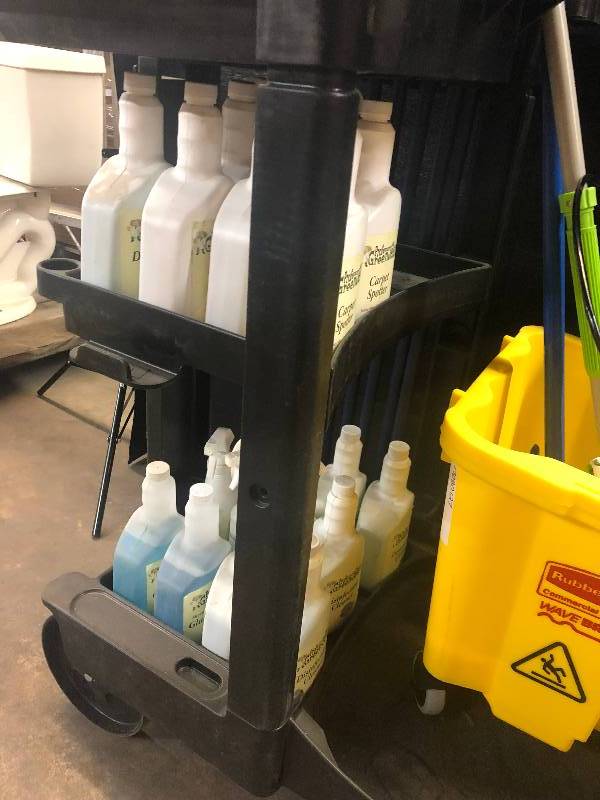 lot 24 image: Janitorial Cart with Mop Bucket, (2) mops, (5) broom handles and a bunch of cleaners