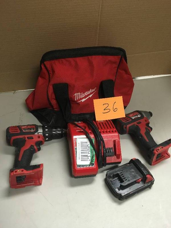 lot 36 image: Milwaukee 12 DrillDriver & 14 Impact Driver Battery Charger and Bag included used in good working condition