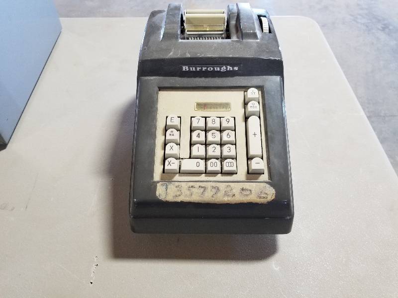 lot 7 image: Vintage Burroughs Calculator, stapler, and file cabinets and a vintage Eureka Vacuum