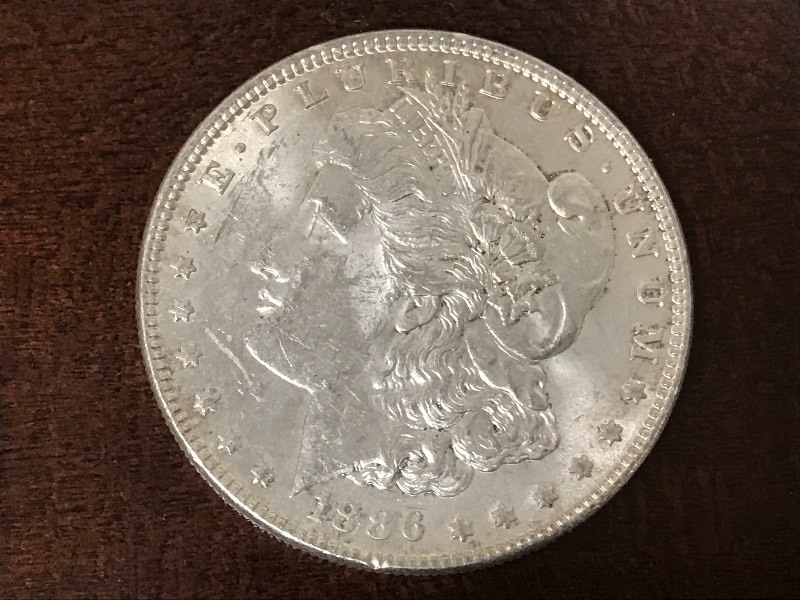 lot 1 image: 1886 Morgan Silver Dollar...