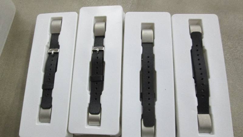 lot 59 image: Lot of 4 FitBit Alta Bands open box...