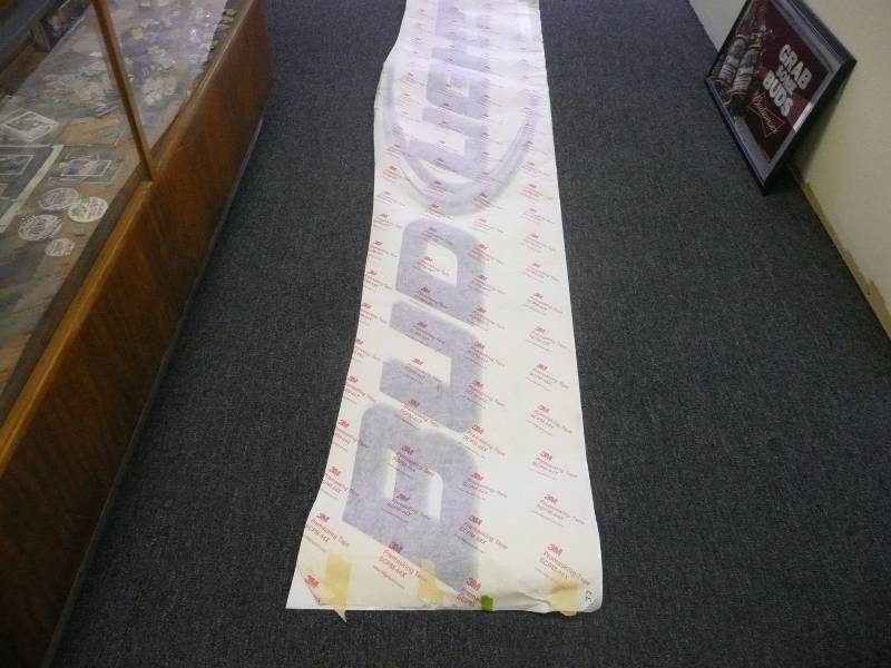 lot 21 image: RARE BUD LIGHT PEEL AND STICK SIGN - CAN BE APPLIES TO ANY FINISHED SURFACE - 3M GRAPHICS PRE MASKING TAPE - APPROX 10FT LONG 2FT HIGH