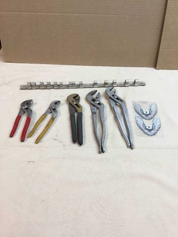 lot 8 image: Five Adjustable Pliers, 12 inch Socket Holder, And Two Fire bird Emblems