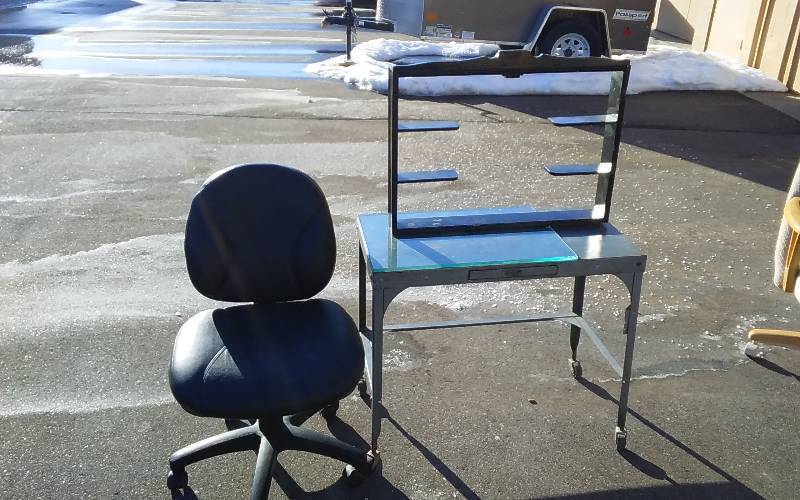 lot 13 image: Black Office Chair, Metal Rolling Table With Drawer 31x16x26, Heavy Glass Panel (Chip) 22x16, Black Shadow Box 27x21