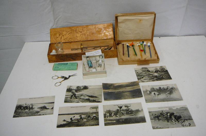 lot 32 image: Vintage Items Kewpie Dolls Postcards Osakis Mn   Wooden Box Glass stir sticks