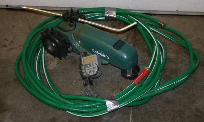lot 24 image: Garden Hose and Tractor Sprinkler