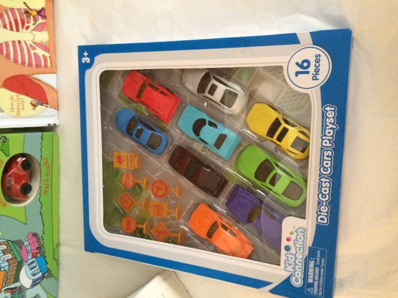 lot 137 image: Fisher Price Potty, Kids Books, and New Box of Toy Cars.