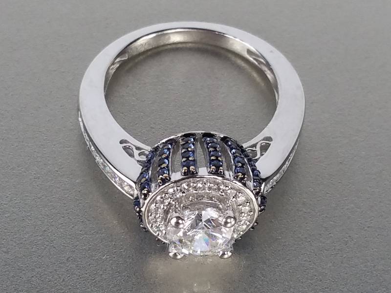 lot 92A image: White and Blue Sapphire Halo Ring in Sterling Silver