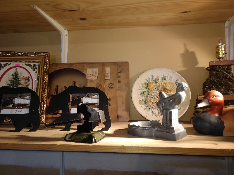 lot 50 image: Photo Frames, Scale, Ornate Ashtray, Loon Figurine, Dog Figurine, C-5730 Rose 1962 Bedford, OH Hand Painted Dish, Lamp Base