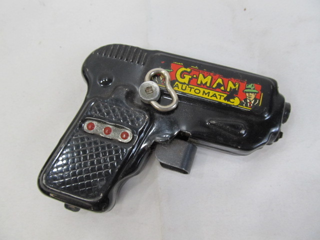 lot 91 image: G-Man Automatic Friction Gun Toy