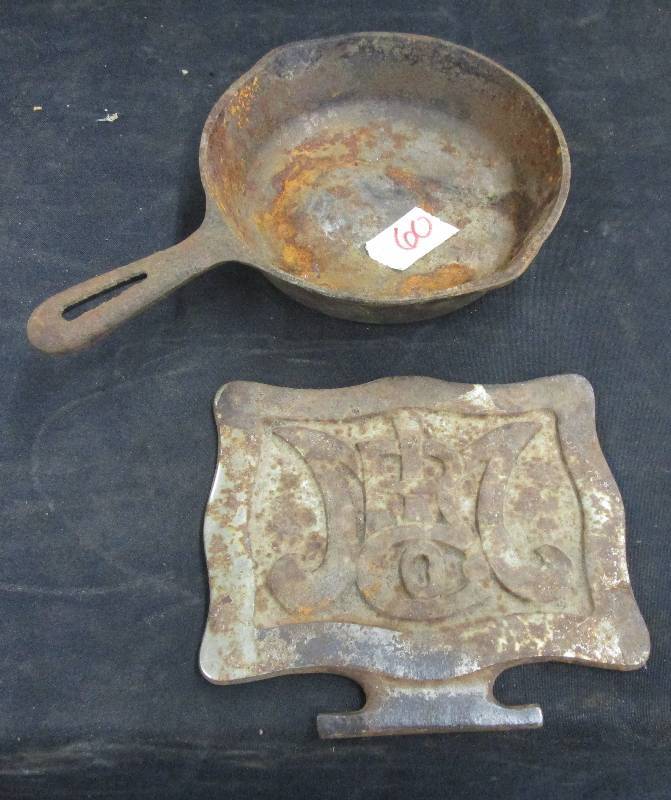 lot 60 image: 6 12 Skillet and Decorative Metal plate for maybe and Old Stove