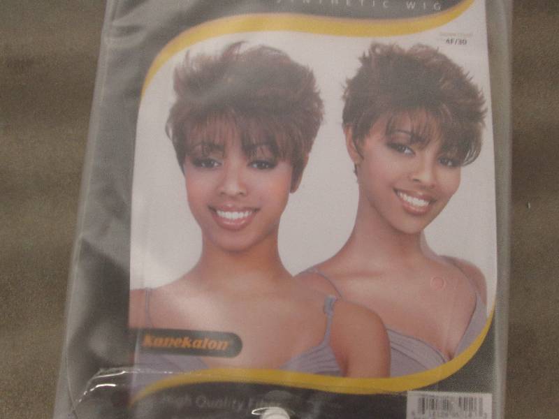 lot 39 image: Motown Tress Smile Wig Retail $34.9...