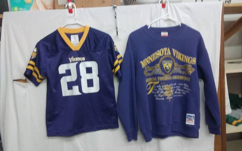 lot 14 image: #28 Vikings Peterson NFL Youth Size L 1214 & Size Med. Sweatshirt
