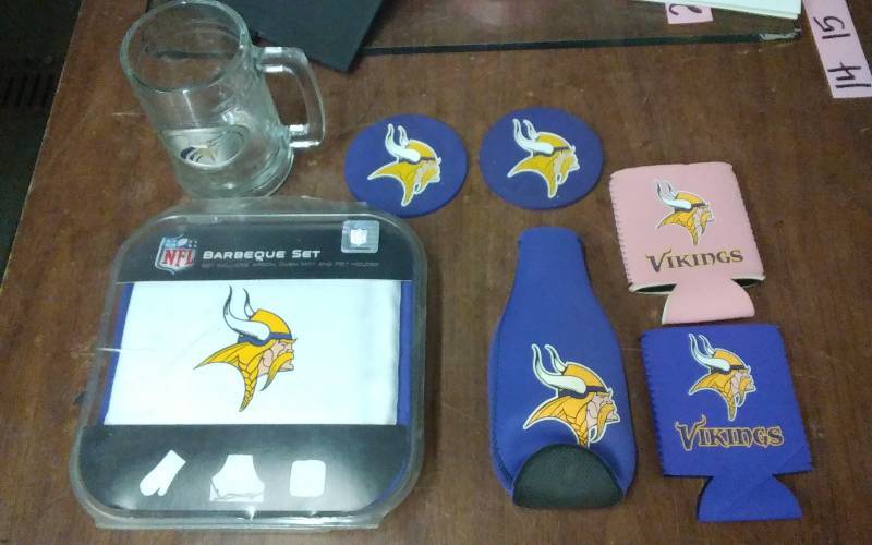 lot 25 image: Vikings BBQ Set (Apron, Oven Mitt Potholder), Beer Stein, Coasters & Coozies