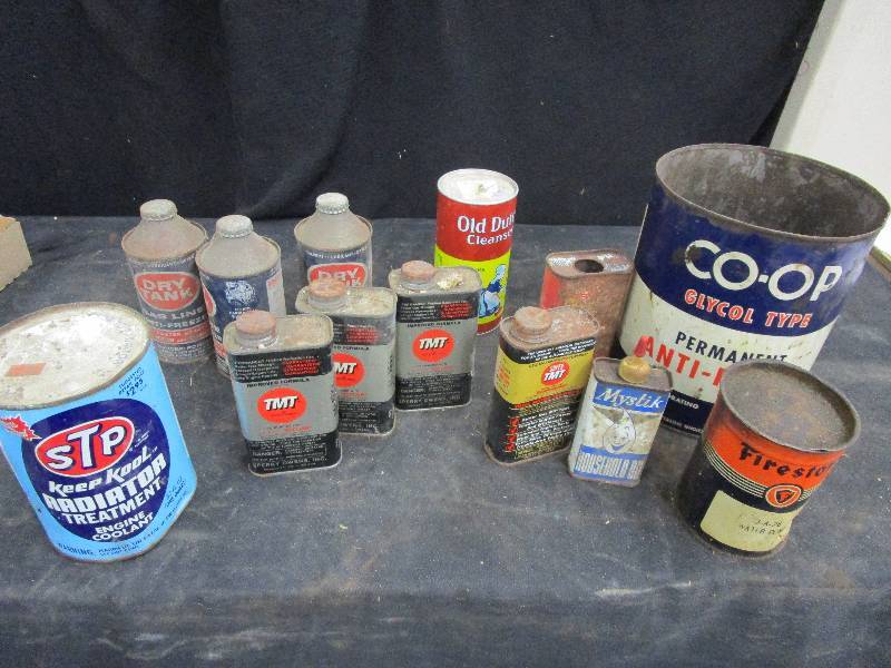 lot 115 image: Various Metal Cans, Most have stuff in them TNT and Firestone and STP Keep Cool Cans