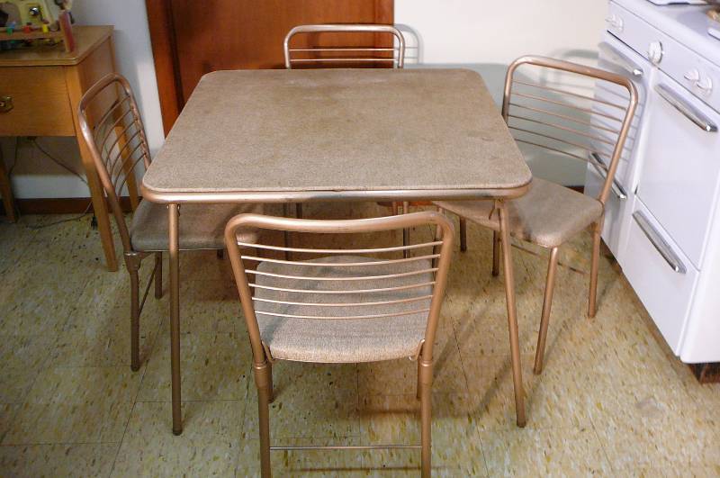 lot 314 image: Cosco Fashion Fold Card table & 4 Chairs, 1 has a tear
