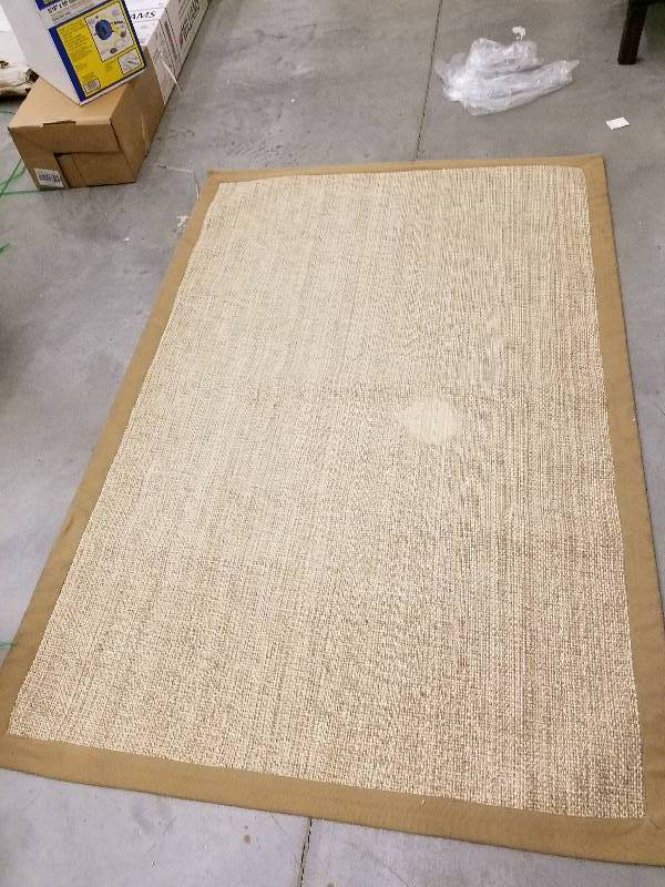 lot 130 image: Salty Coast Tan 5 ft. 1 in. x 7 ft. 6 in. Border IndoorOutdoor Area Rug