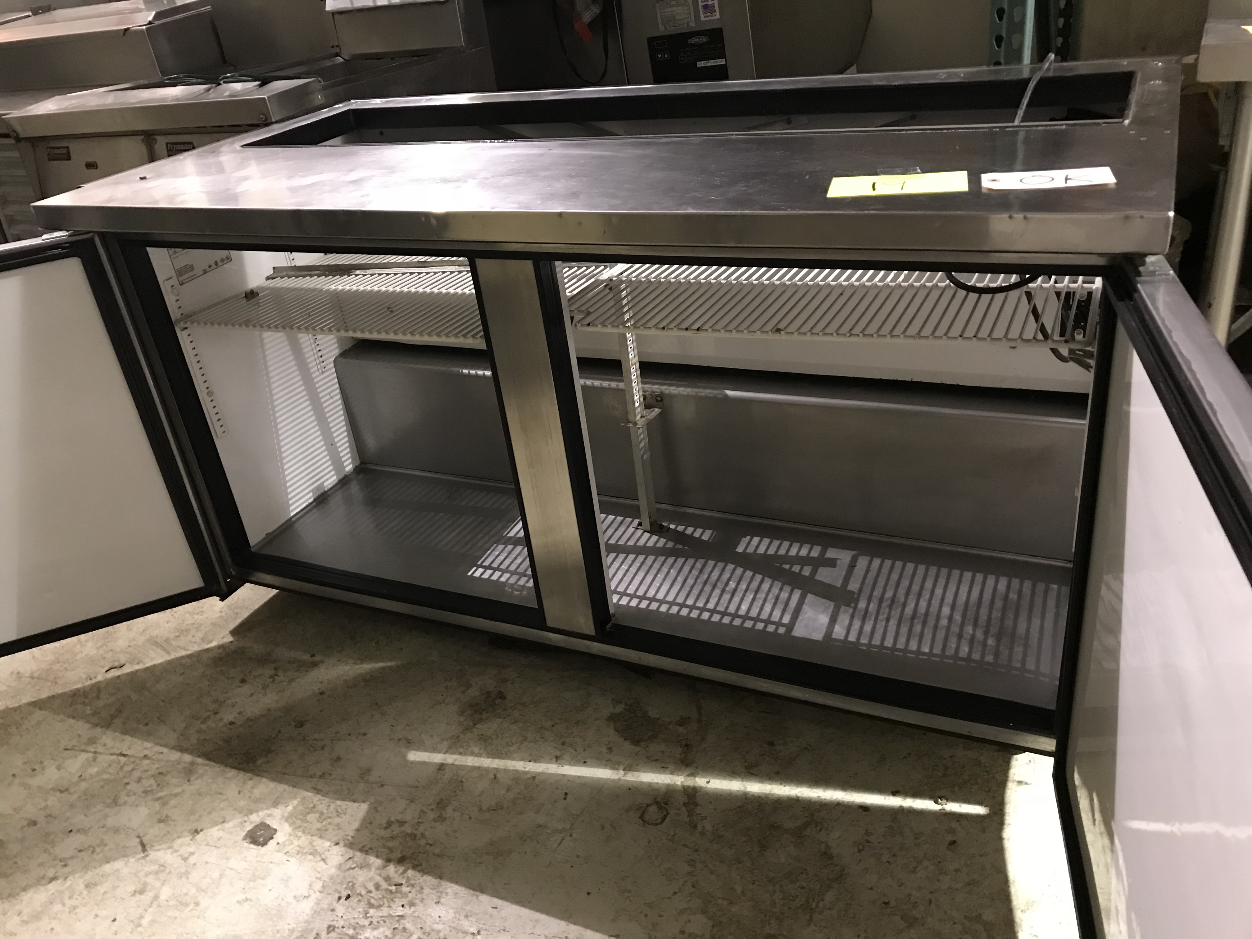 lot 19 image: True Two Door Sandwich Prep Table on Casters - Model # TSSU-60-16  Runs Cools