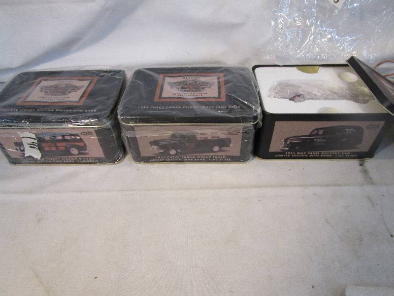 lot 15 image: Set of Three Harley Davidson Dime Banks. 1951 GMC Delivery Van, 1955 Chevy Cameo PU. Truck, 1940 Ford Woody Station Wagon.