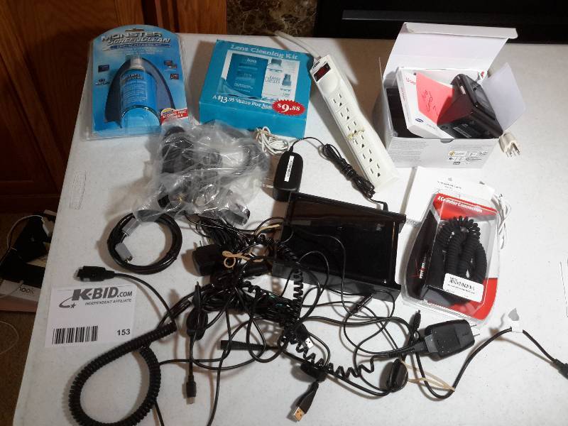lot 153 image: Large lot of cords, a Samsung Flip phone, Screen Cleaners, Router