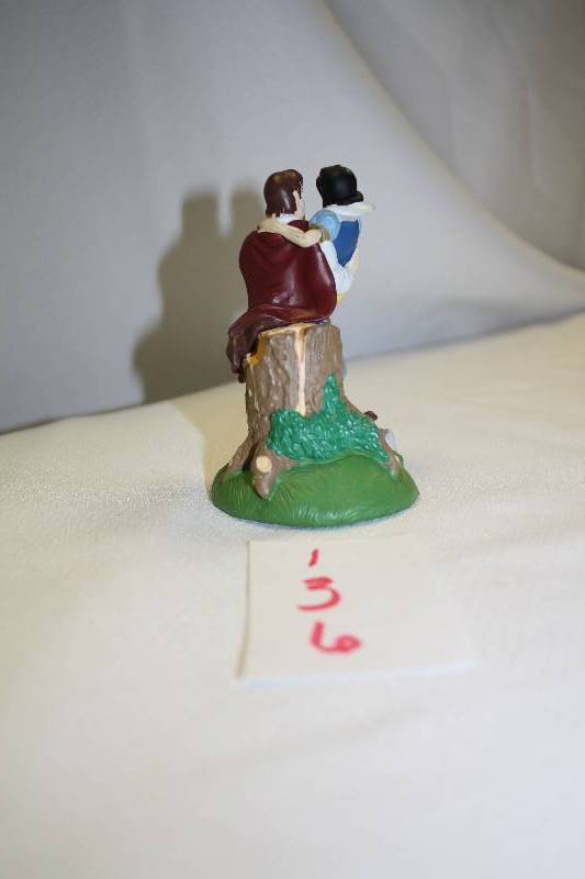 lot 136 image: Snow White and Prince Charming sitting on tree stump figure
