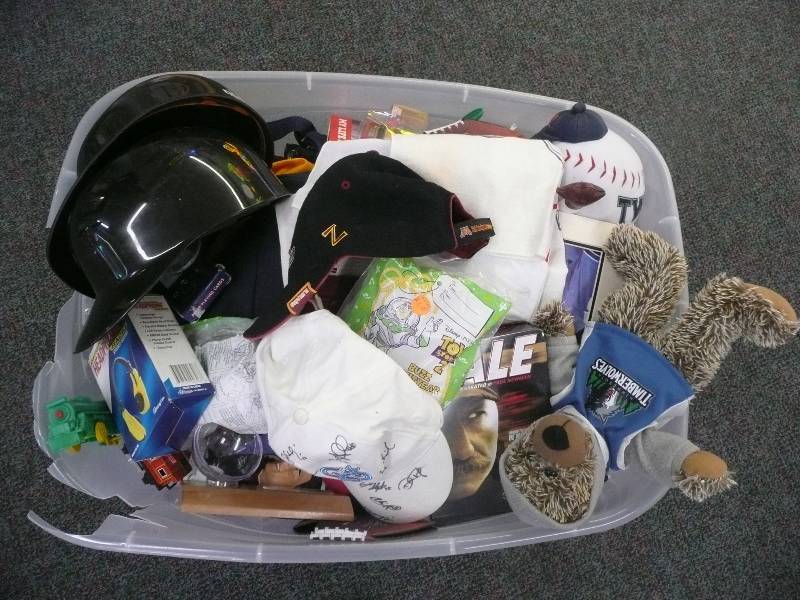 lot 48 image: VERY LARGE TOTE FILLED WITH SPORTS COLLECTIBLES - HATS - FIGURES - SIGNED ITEMS - WILD, ST PAUL SAINTS, TWINS, TIMBERWOLVES, GOPHERS, VIKINGS, NASCAR TO MUCH TO LIST - SEE PICTURES