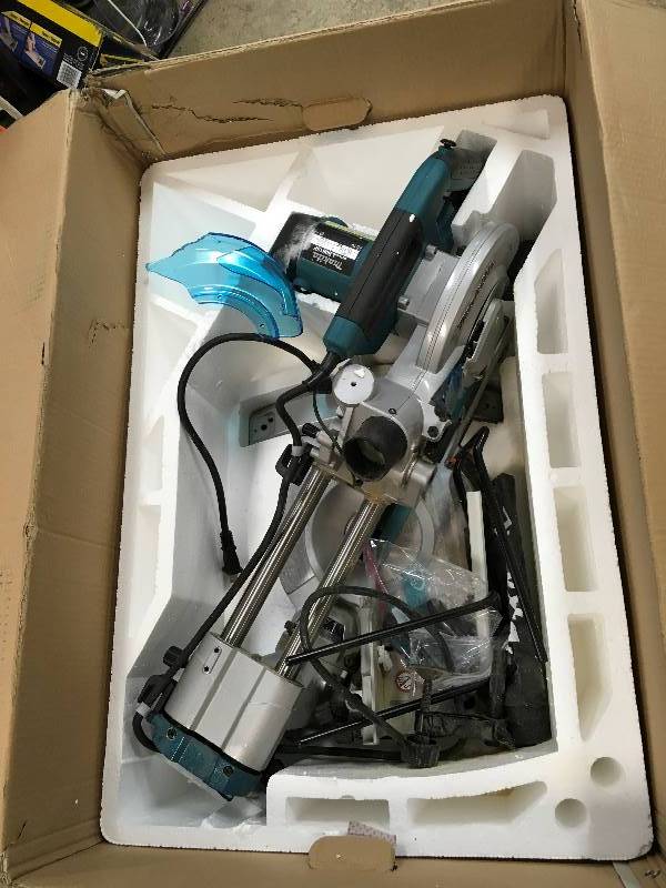 lot 26 image: Makita USA  812 in. Slide Compound Miter Saw broken blade guard in good working condition