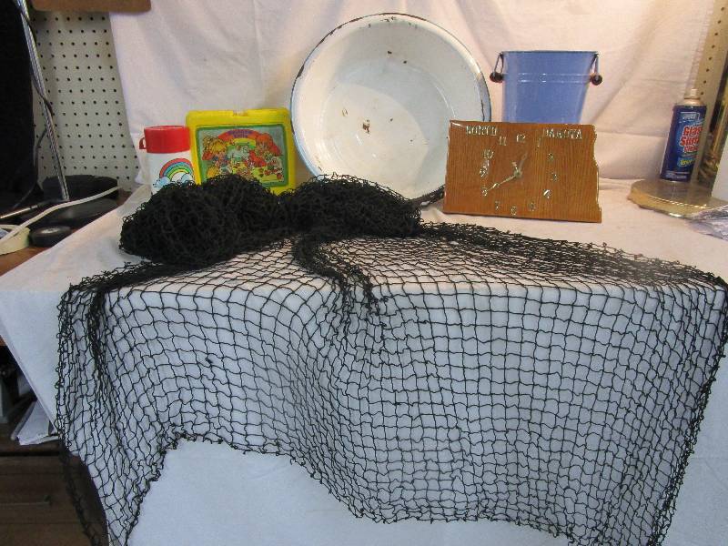lot 142 image: 14 x 4 Decorative Fish NetRainbow Brite Lunch Box and Thermous, North Dakota Clock and Decoative Bucket and Shelf