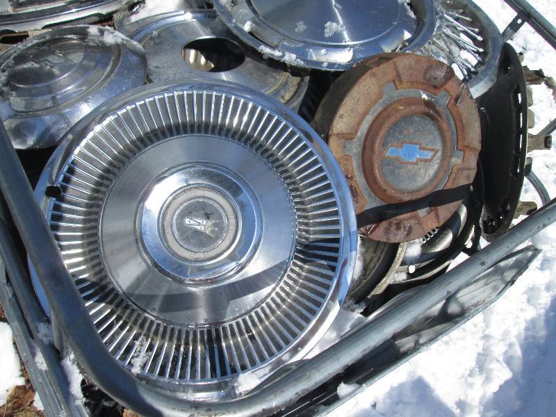 Bin of vintage hubcaps from 1950 - ...