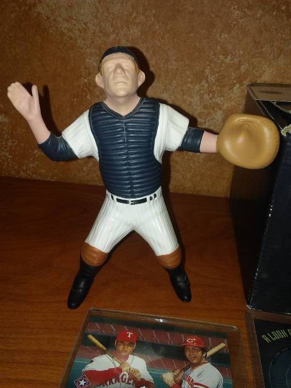 lot 29 image: Yogi Berra and Ivan Rodriguez statues and cards.