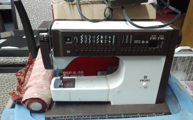 lot 78 image: Viking Sewing Machine, Sewing Notions, 2-Totes Of Fabric & Patterns