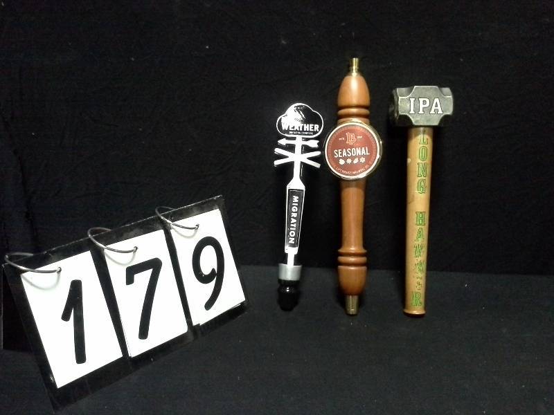 lot 179 image: Lift Bridge Brewing Seasonal, Long Hammer IPA and Bad Weather Brewing Company Migration tap handles